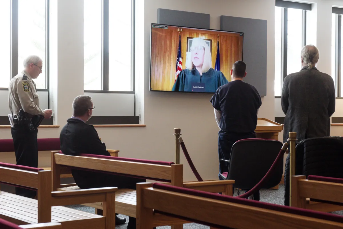 Hallway inside a state courthouse with people waiting outside courtrooms