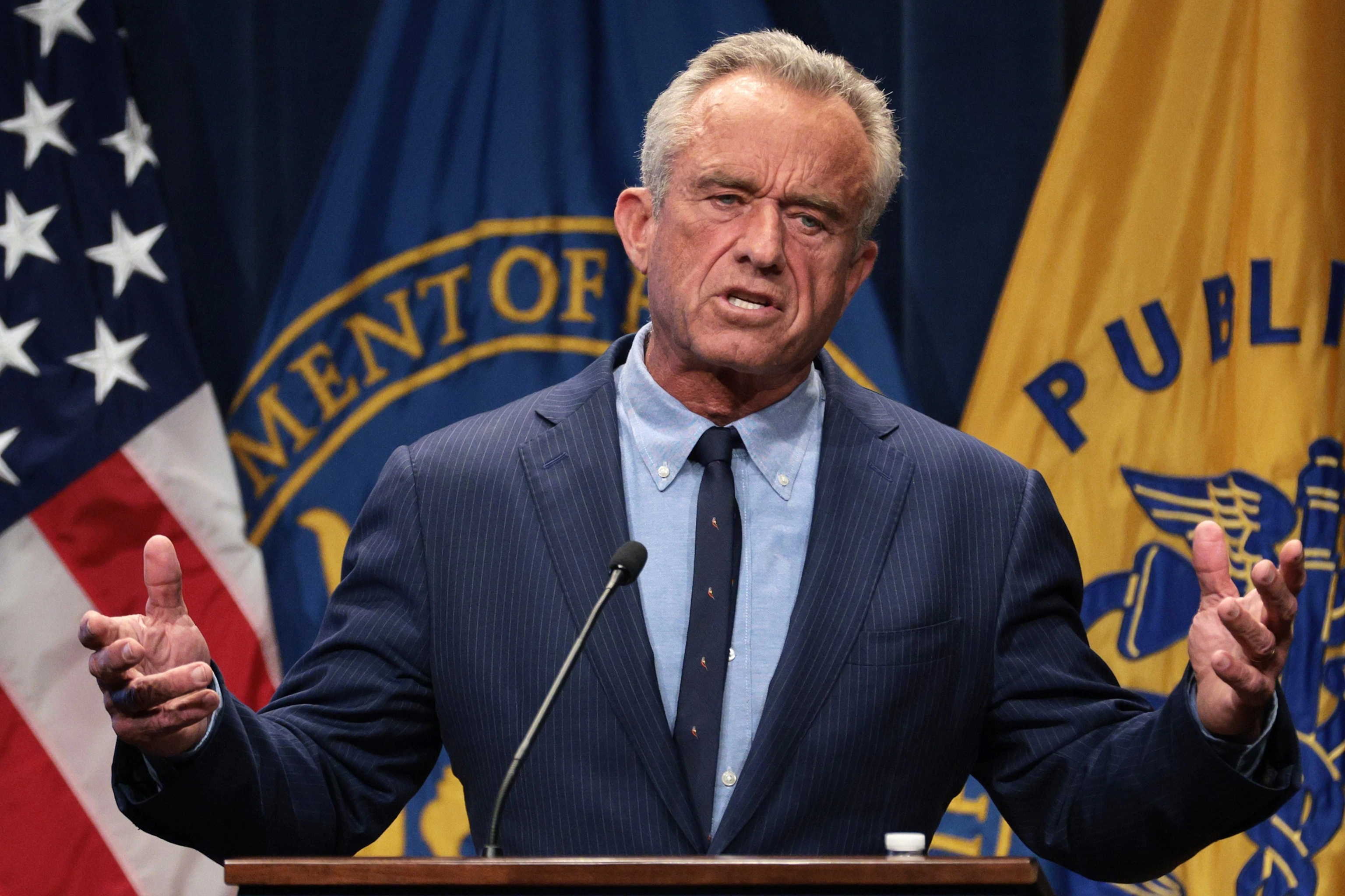 Health and Human Services Secretary Robert F. Kennedy Jr. speaking at a lectern during a public appearance