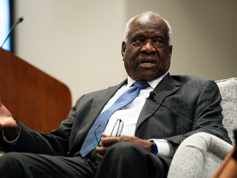 Justice Clarence Thomas seated on the Supreme Court bench during a public session, formal courtroom photography style