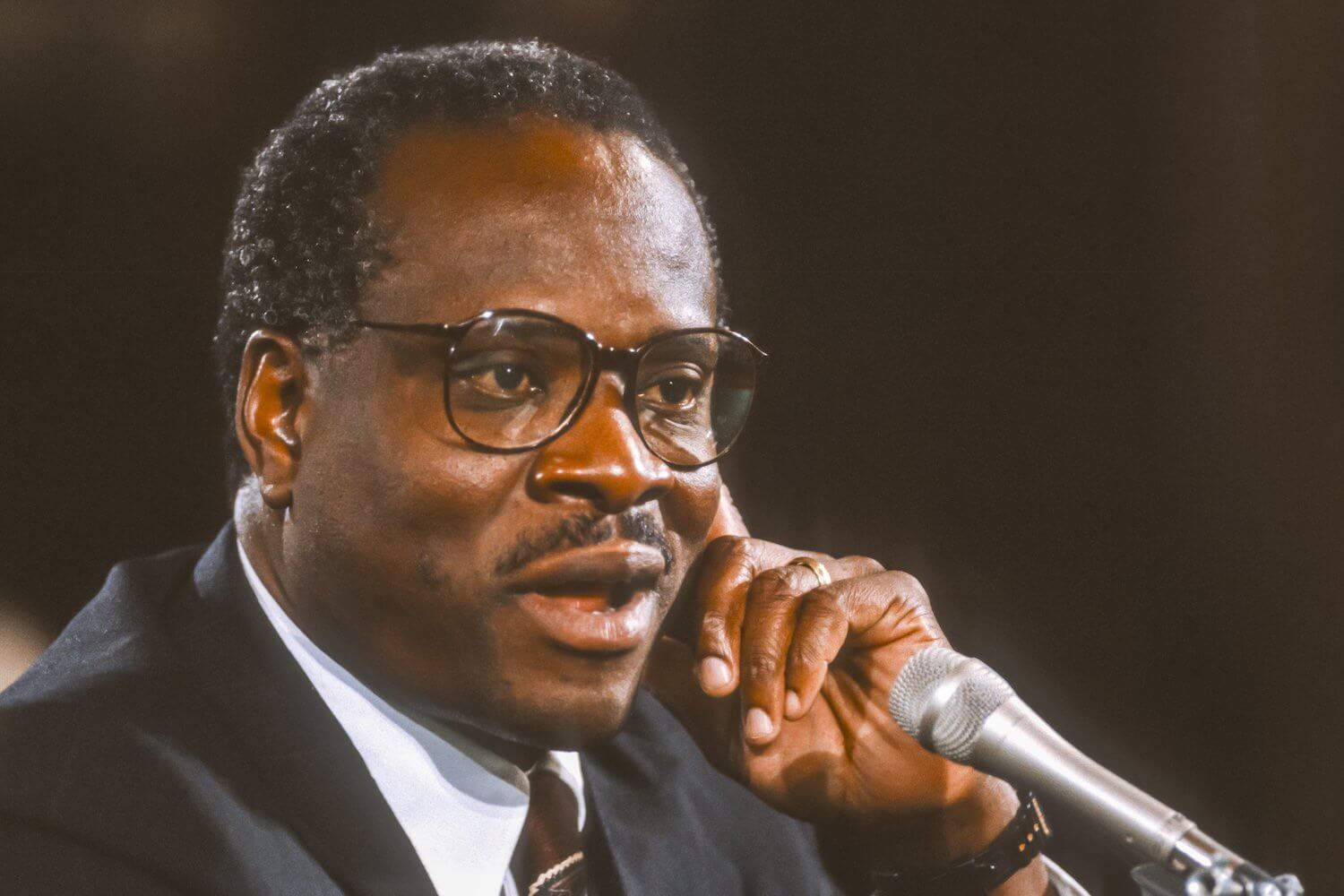 Justice Clarence Thomas standing outside the U.S. Supreme Court in Washington, D.C., news photography style