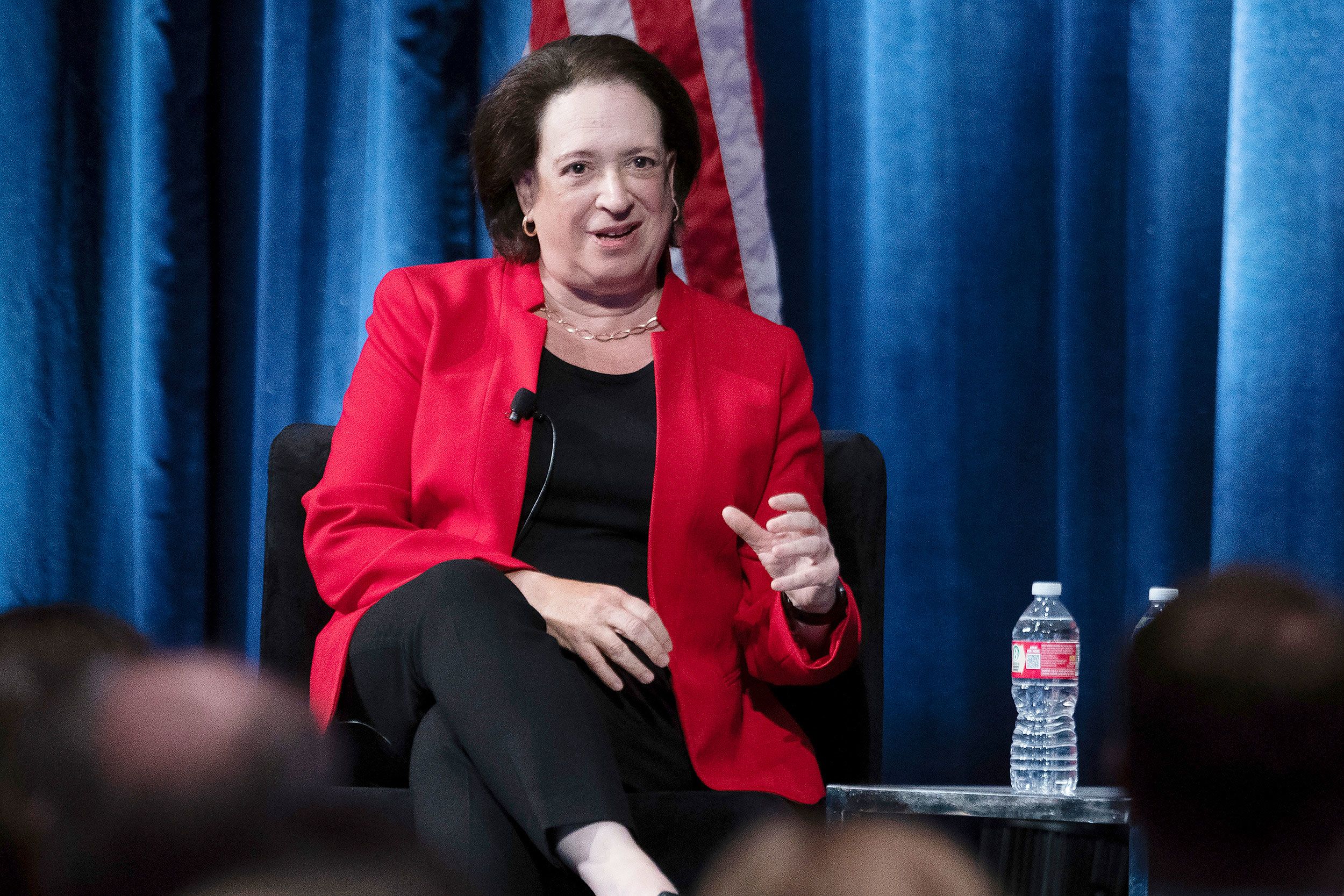 Justice Elena Kagan speaking at the Ninth Circuit Judicial Conference, standing at a podium with attendees seated in front of her