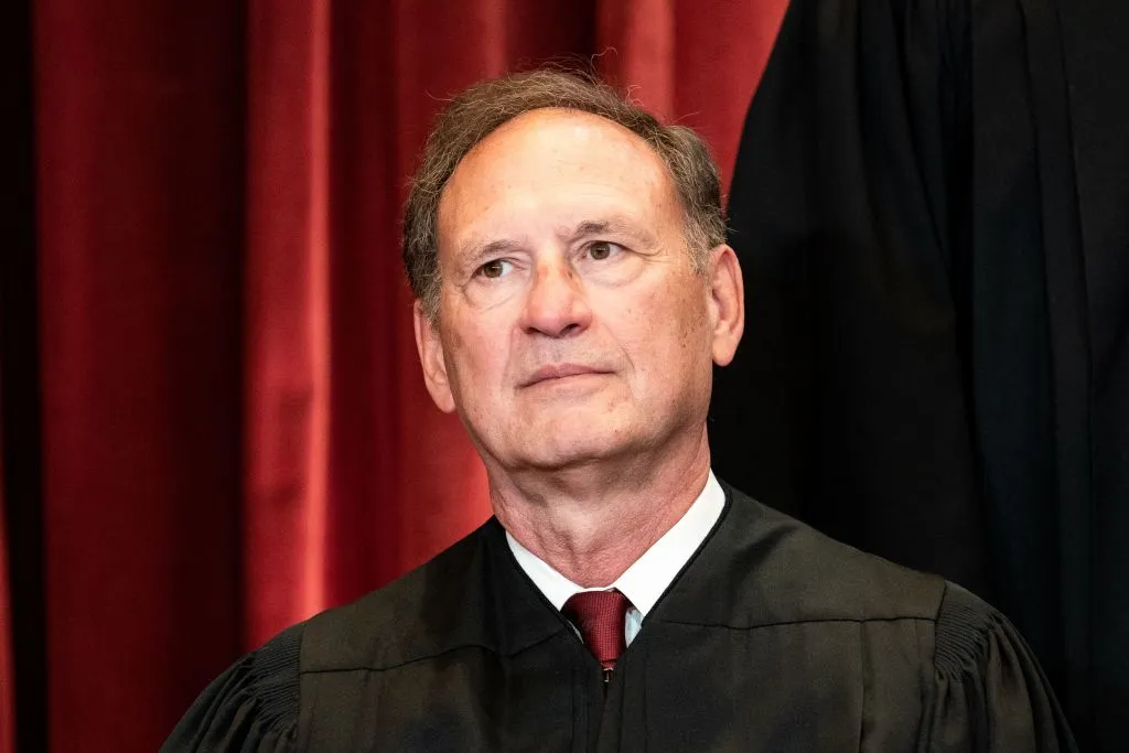 Justice Samuel Alito walking on the steps outside the U.S. Supreme Court building in Washington, D.C., news photography style