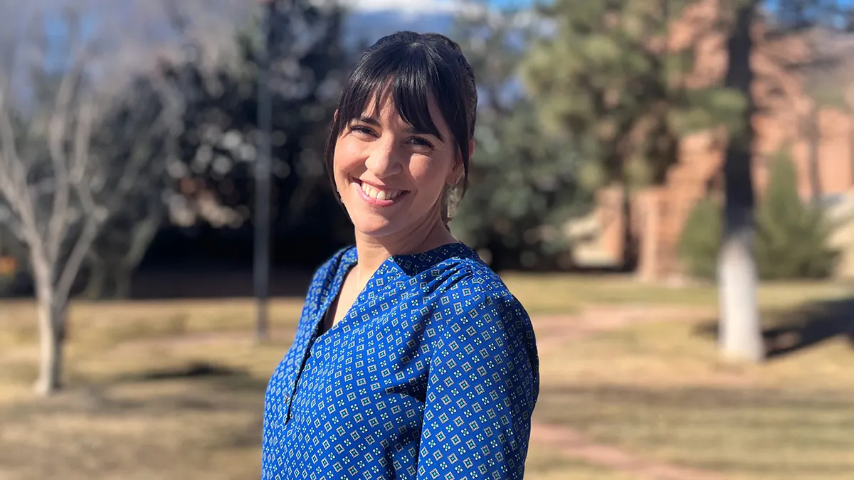 Kaley Chiles, a licensed therapist, walking outdoors in Colorado Springs near an office building in daytime, documentary news photo style