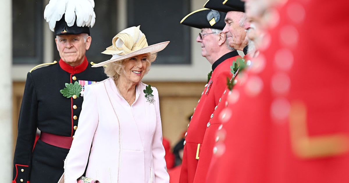 King Charles III greeting members of the public during an outdoor engagement, smiling and shaking hands