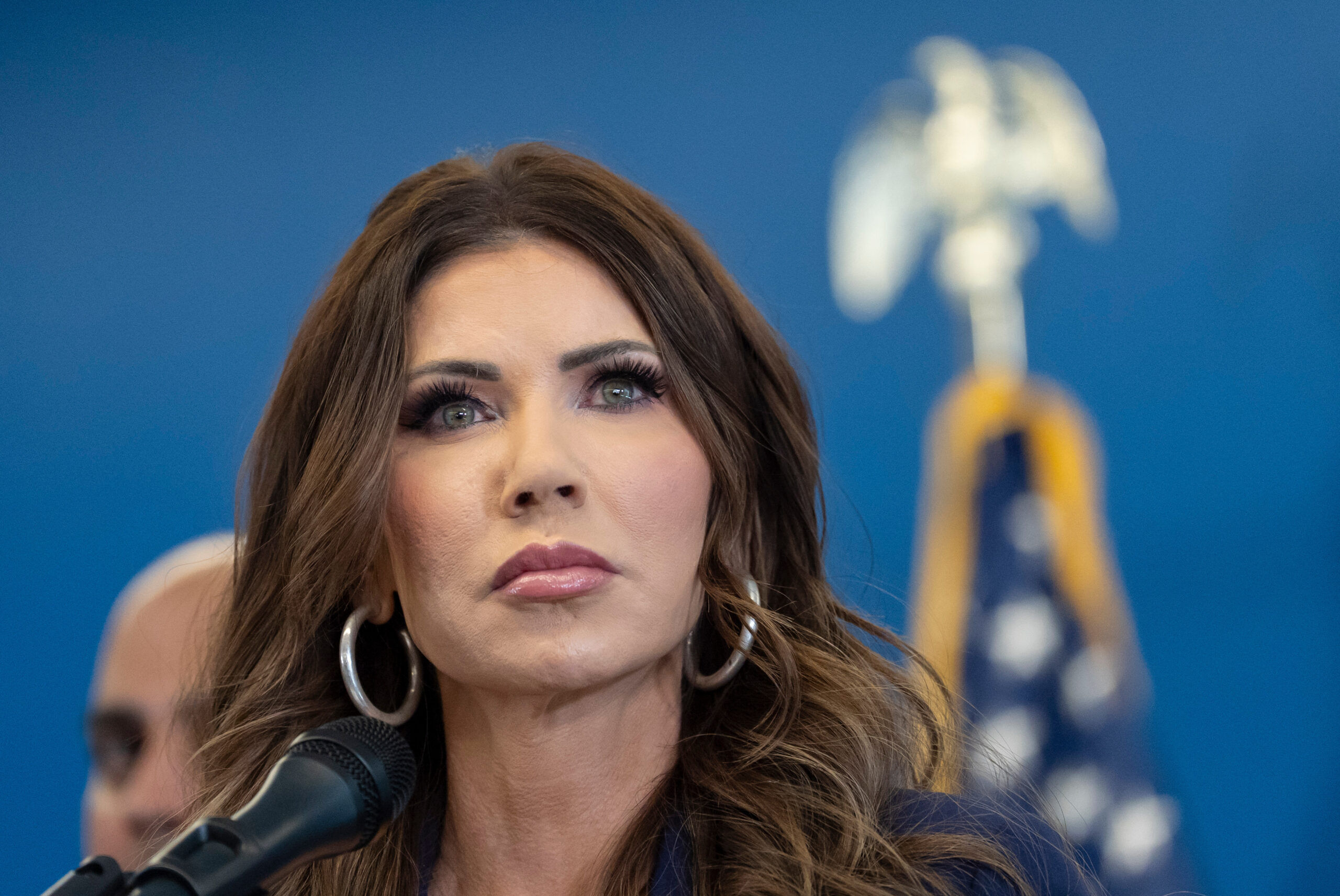 Kristi Noem speaking at a Department of Homeland Security press conference in 2026, news photography style