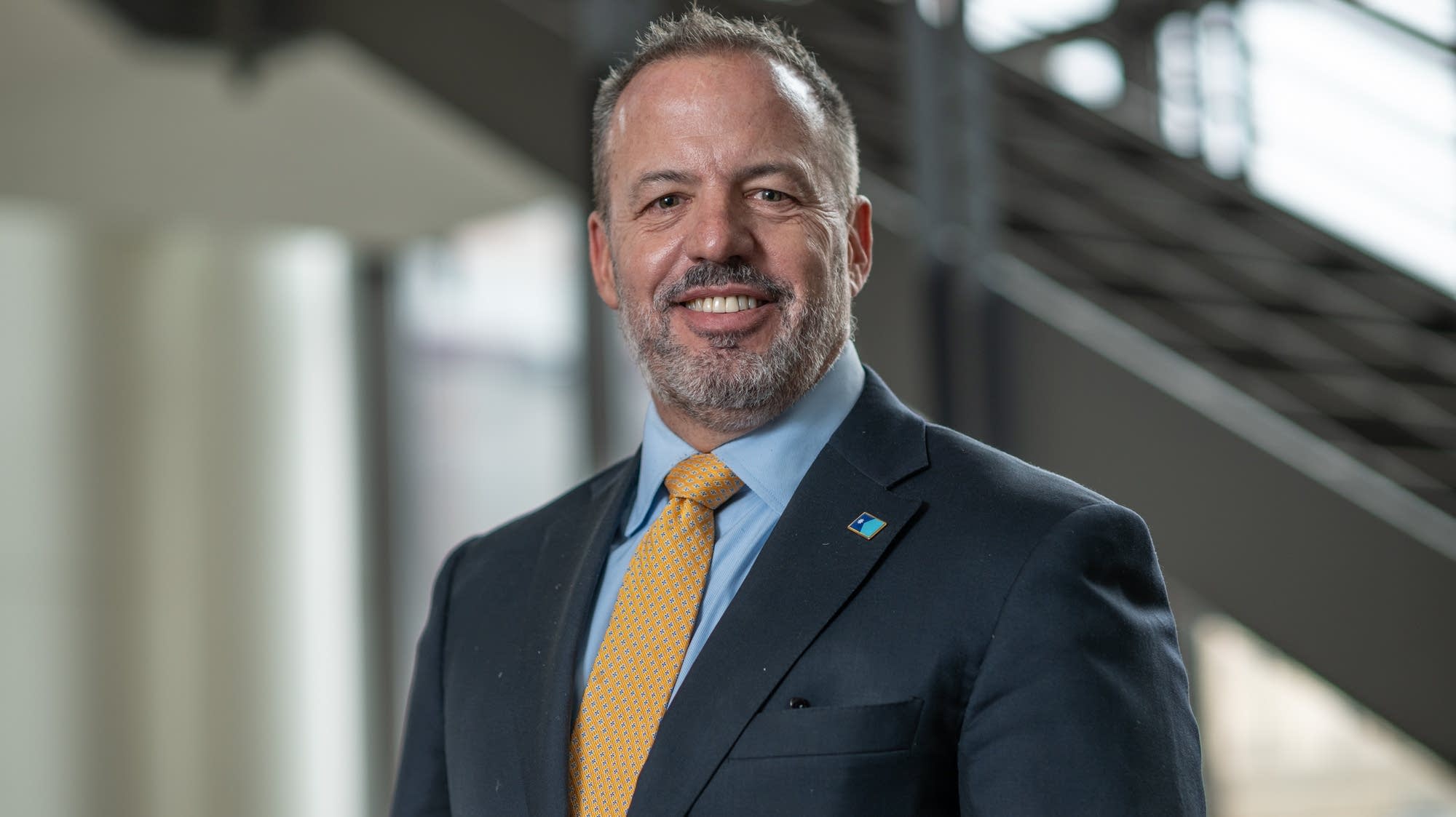 Matt Klein, a Minnesota state senator and congressional candidate, speaking to voters at a campaign event in Minnesota, news photography style