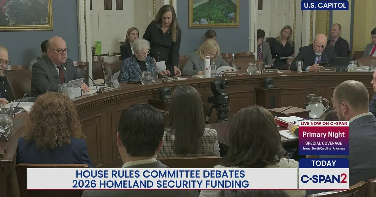 Members and staff gathered in a hearing room during a House Rules Committee meeting at the U.S. Capitol, news photography style