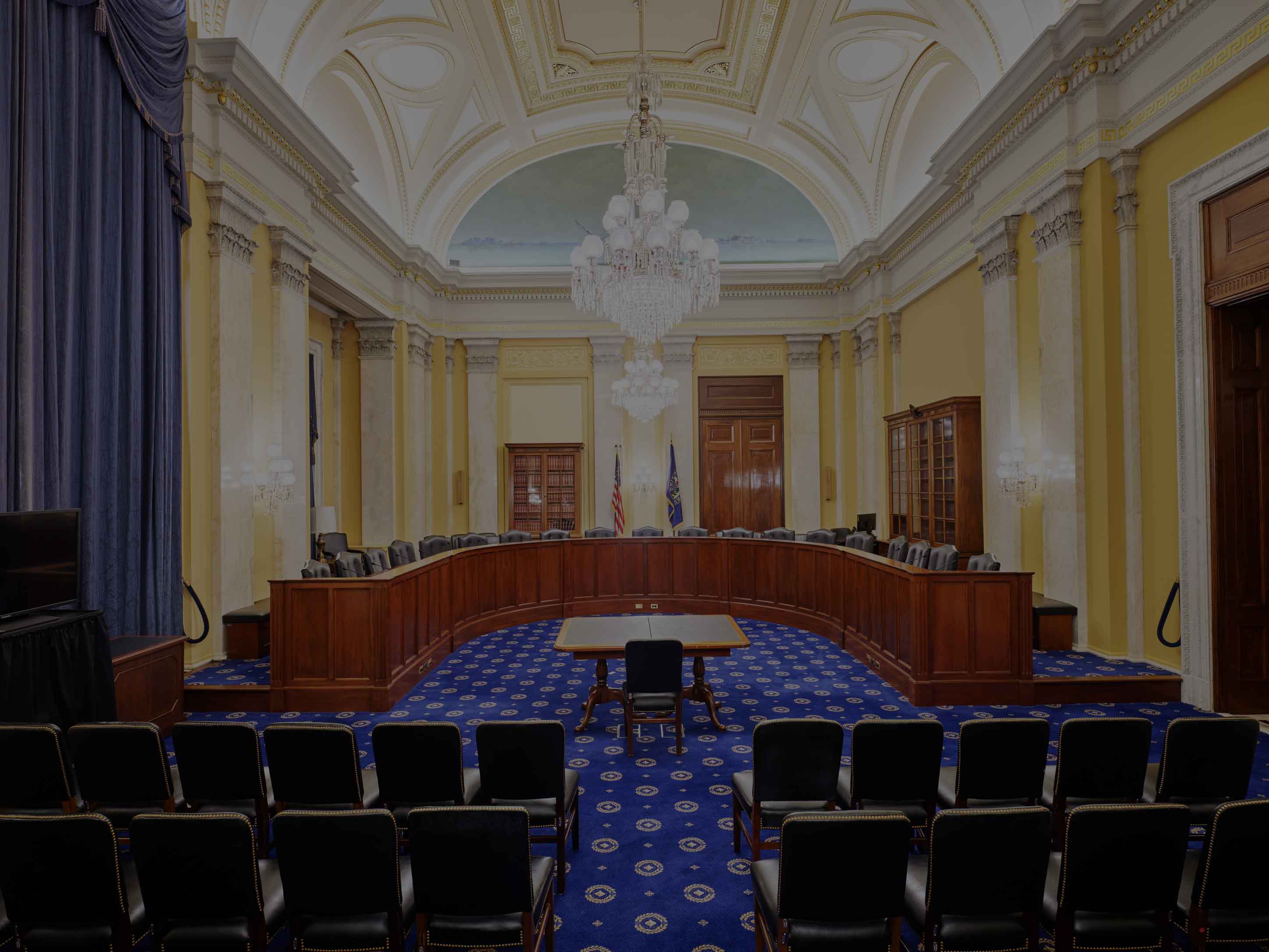 Members of the House Rules Committee sit at the dais during a committee hearing.