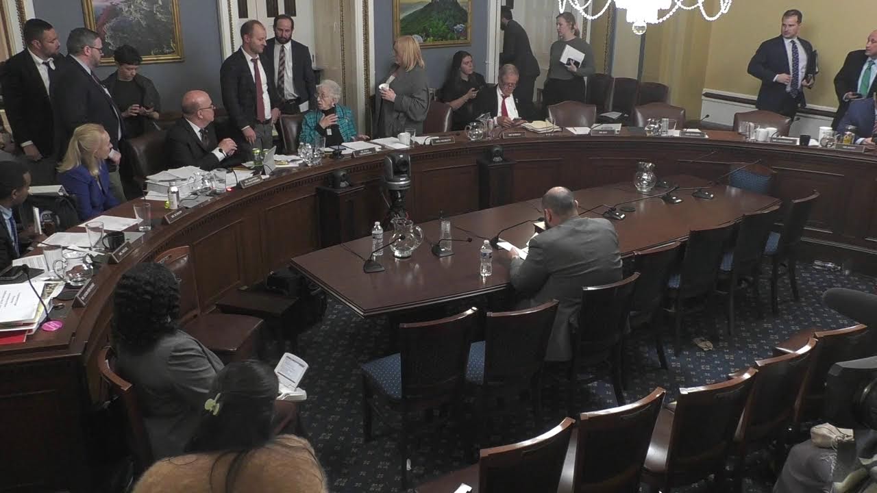 Members seated at the House Rules Committee dais during a hearing in Washington, D.C., with staff and witnesses visible, news photography style