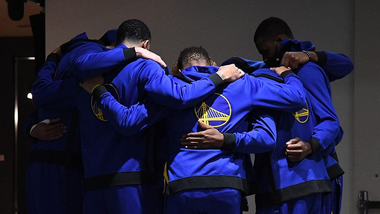 Moses Moody playing for the Golden State Warriors during an NBA game, shown on the court in uniform
