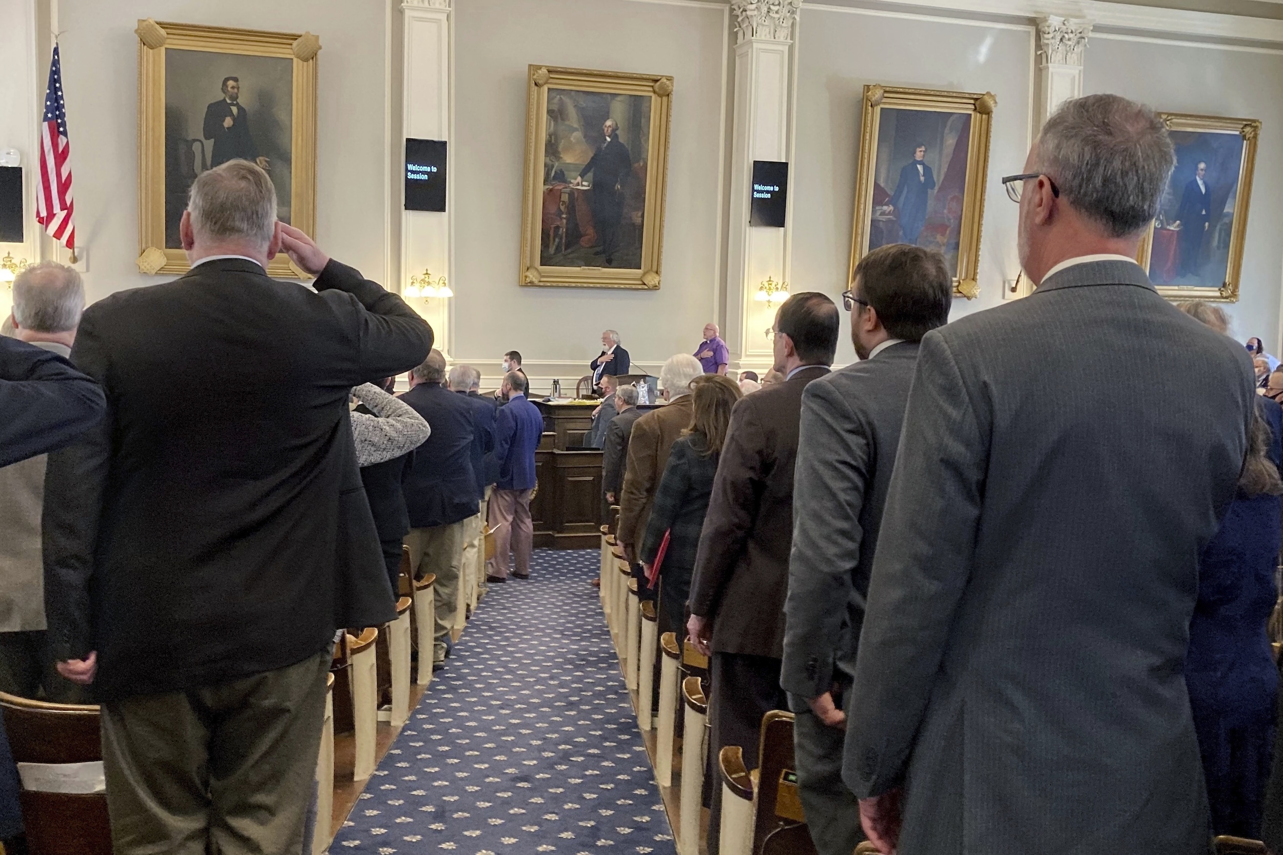 New Hampshire state Sen. Bill Gannon speaking to reporters in a State House hallway, indoor news photography style