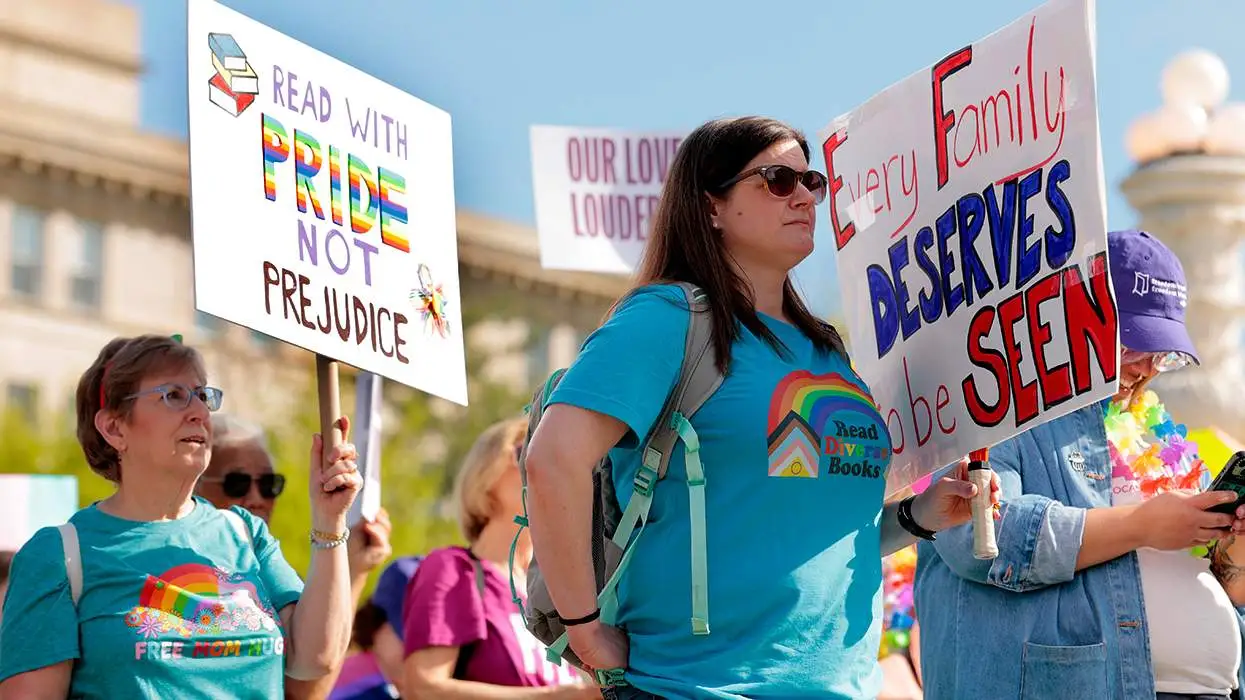 Parents and advocates gathered outside the U.S. Supreme Court in Washington, D.C., holding signs during a public demonstration, news photography style