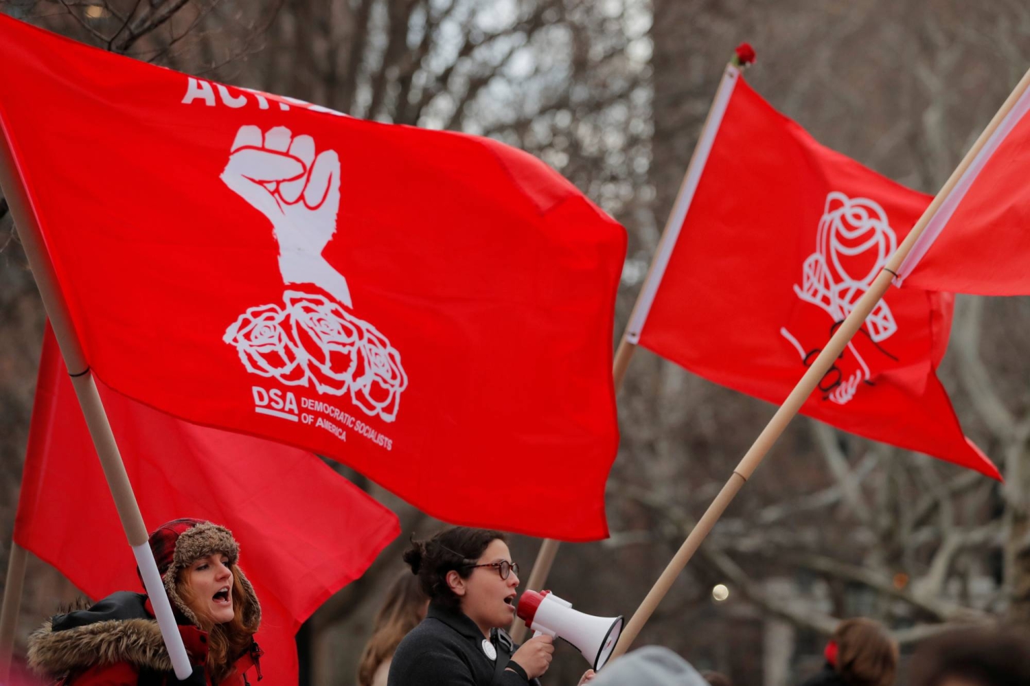 People holding signs at a Democratic Socialists of America event
