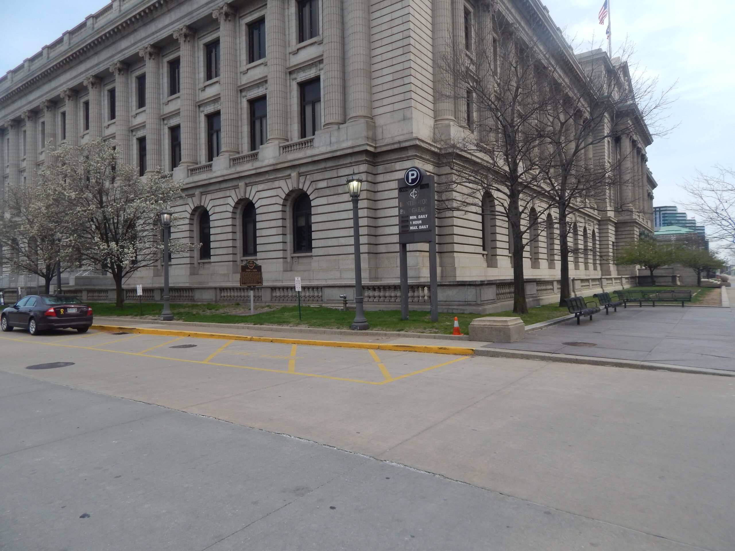 Photograph of the United States Supreme Court steps on an overcast day, with a few people walking up the stairs and a police officer visible near the entrance