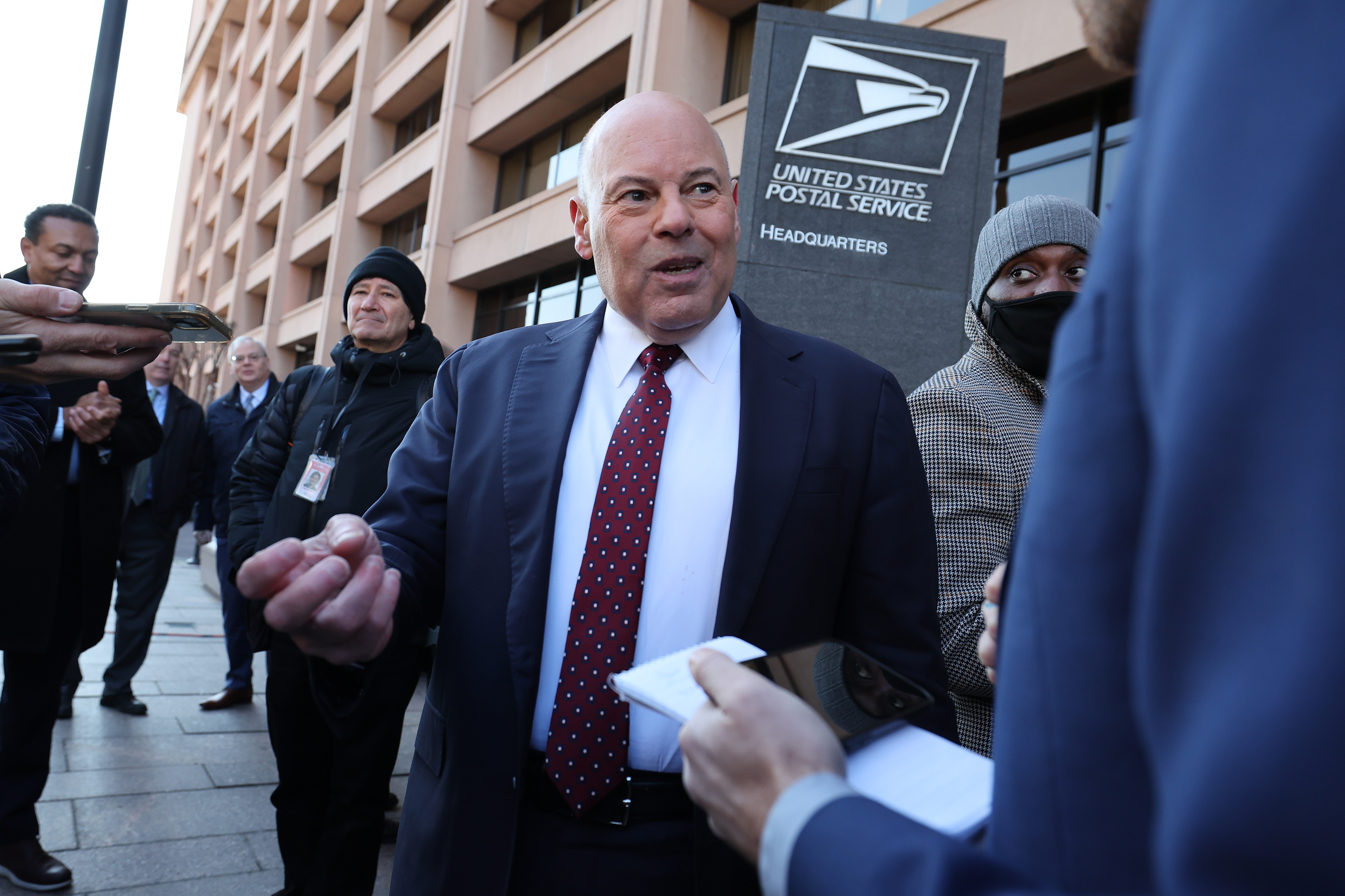 Postmaster General David Steiner speaking at a lectern during a public appearance