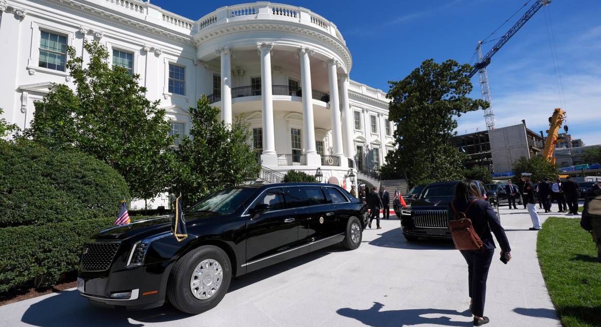 President Donald Trump departing for travel with Air Force One and security personnel visible during a public presidential movement