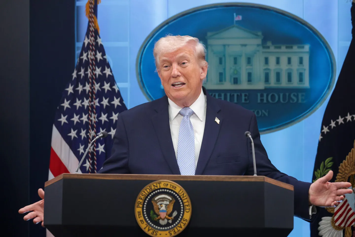 President Donald Trump speaking at a lectern in a formal White House setting, news photography style