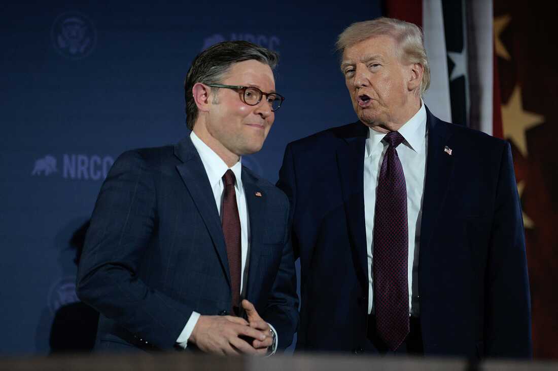 President Donald Trump speaking at a podium with microphones during a press availability, news photography style