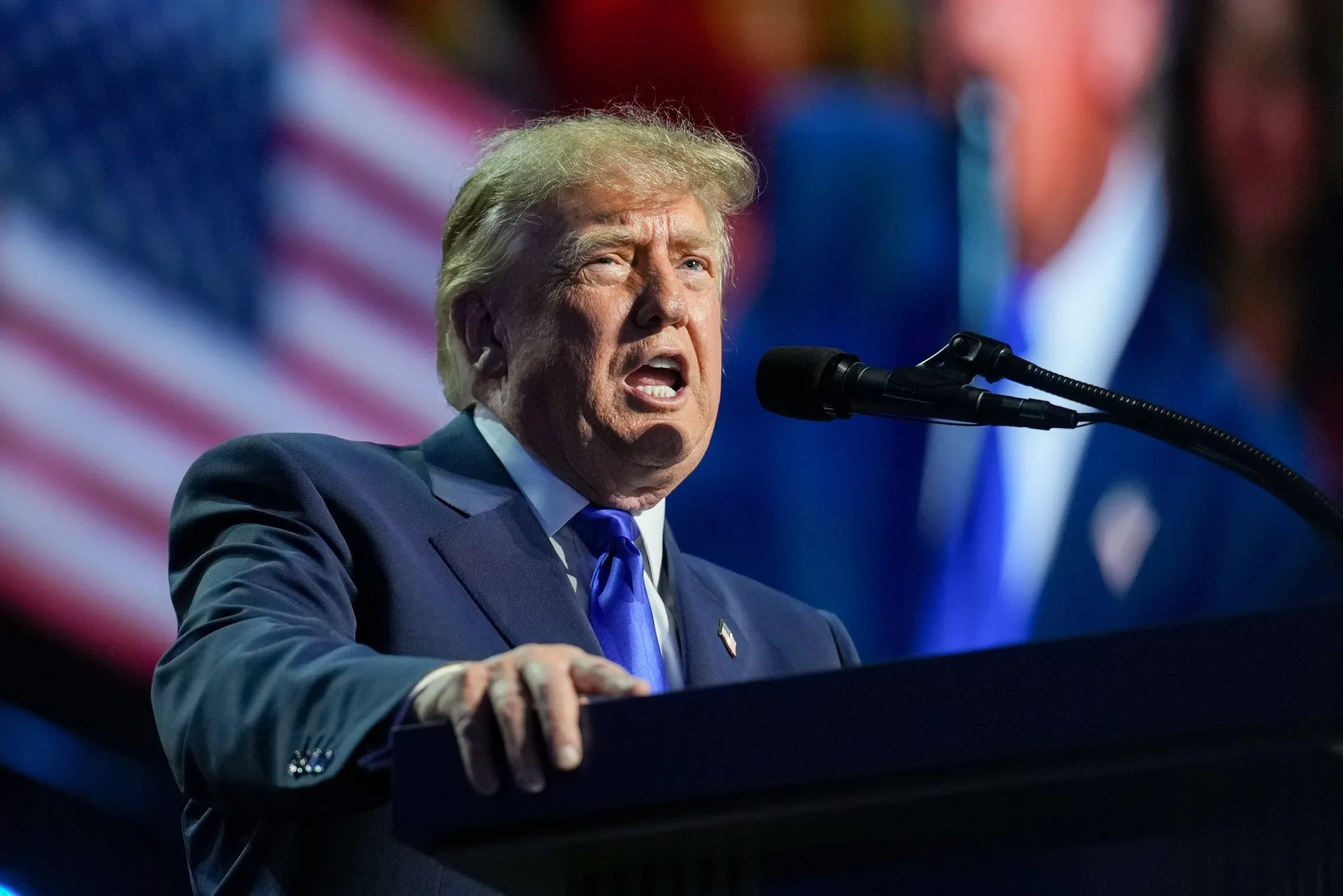 President Donald Trump speaking at the GOP midterm convention in Dallas, Texas, at a large indoor arena event
