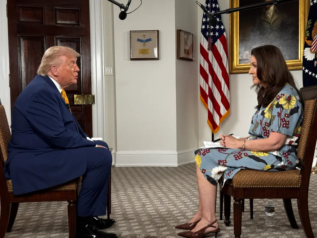 President Donald Trump speaking during an interview setting, news photography style