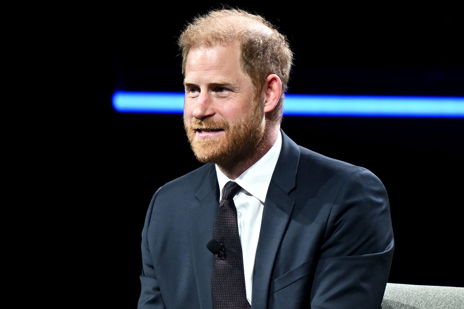 Prince Harry, Duke of Sussex, arriving at a public event and greeting onlookers outdoors