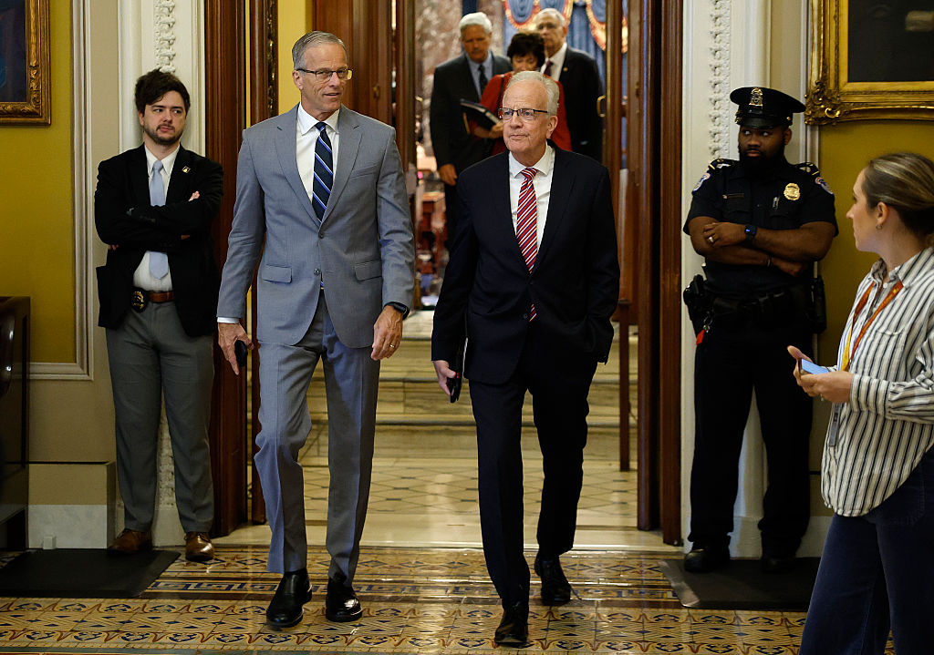Republican senators gathered in a hallway outside the Senate chamber in a tense conversation with reporters nearby, photorealistic news photography