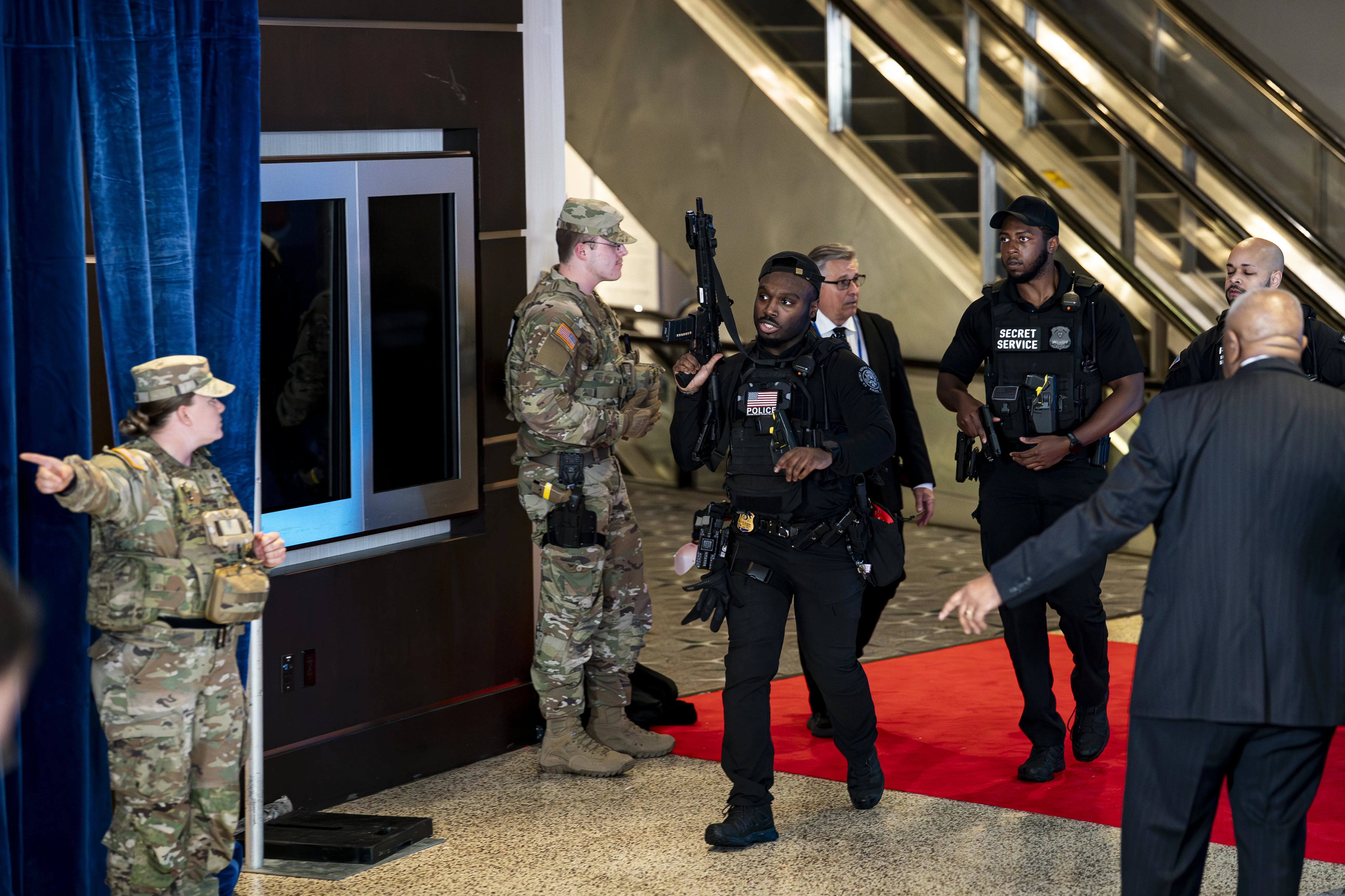 Secret Service agents moving quickly near the ballroom area during the White House Correspondents’ Dinner at the Washington Hilton in Washington, DC, news photography style