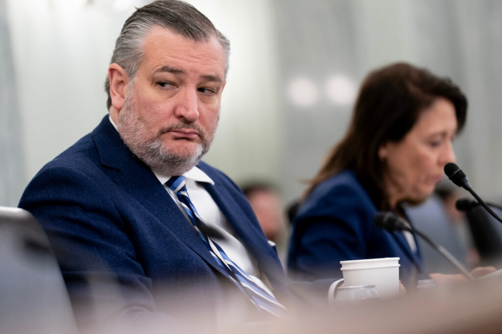 Senator Ted Cruz speaking during a sit-down interview indoors, wearing a suit, news photography style