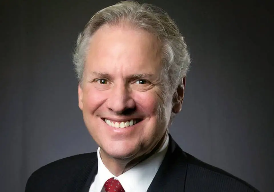 South Carolina Gov. Henry McMaster speaking at a podium during a public event with state flags behind him
