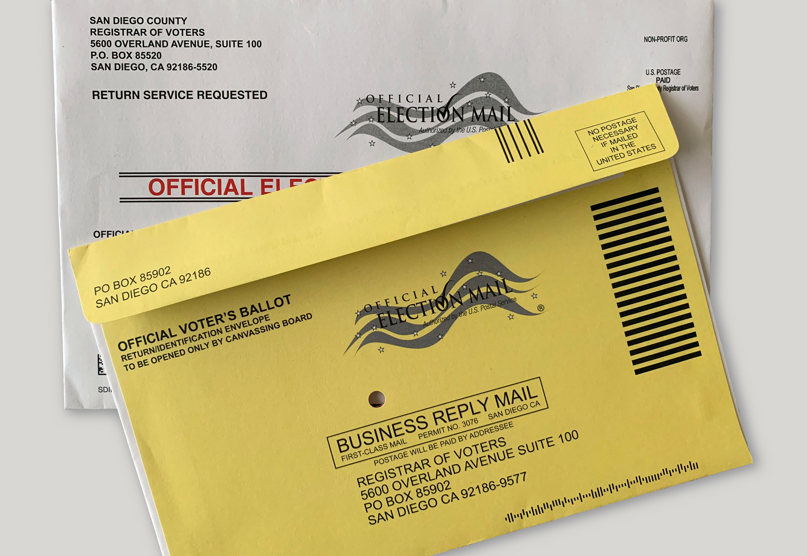 Stacks of official California vote-by-mail ballots and envelopes staged for processing at an elections facility
