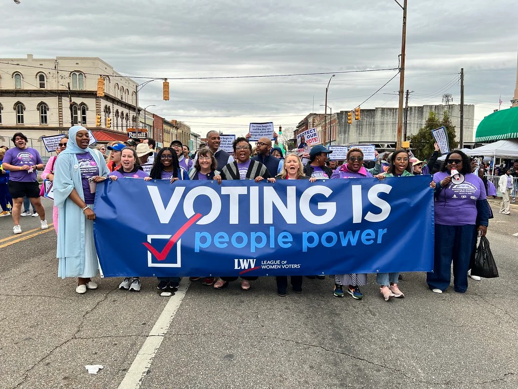 Supporters of the League of Women Voters Massachusetts at a public voting rights event.