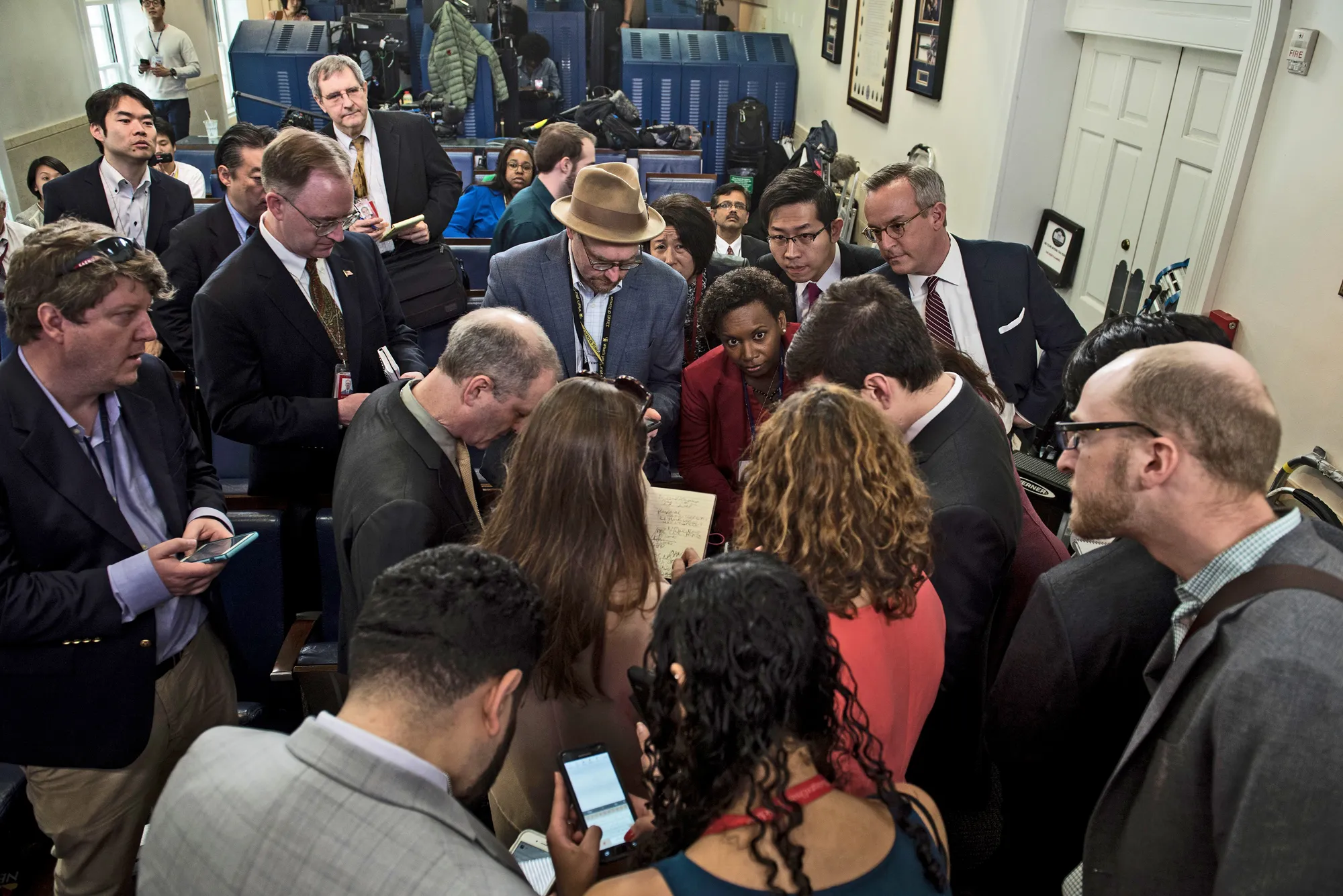 Television camera crews and reporters working on the White House grounds during a public press availability
