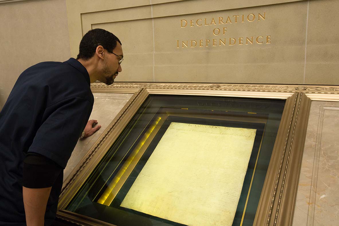 The Declaration of Independence on display at the National Archives in Washington, D.C., viewed through protective glass