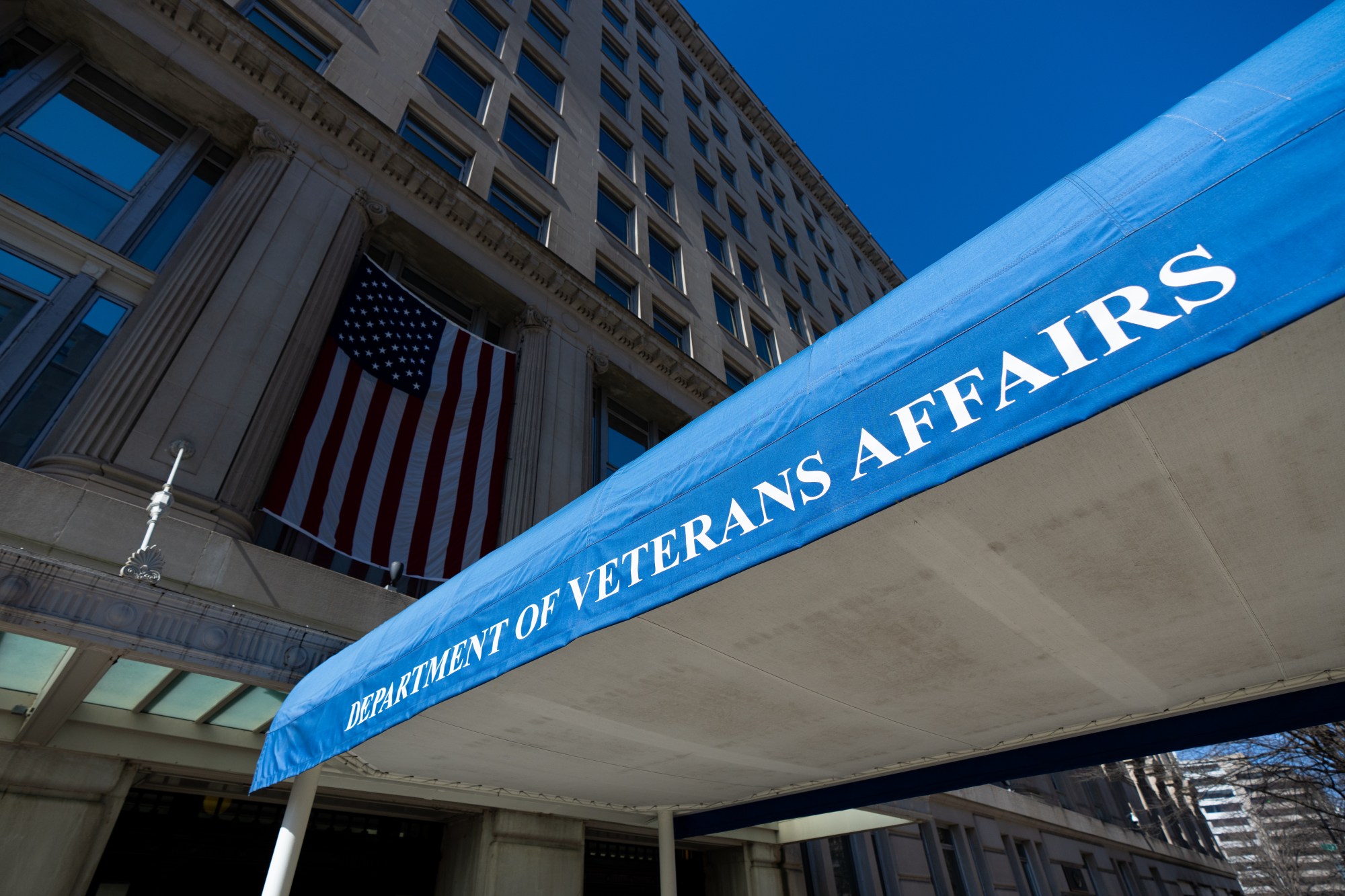 The Department of Veterans Affairs headquarters building in Washington, D.C., photographed from street level with the VA signage visible.