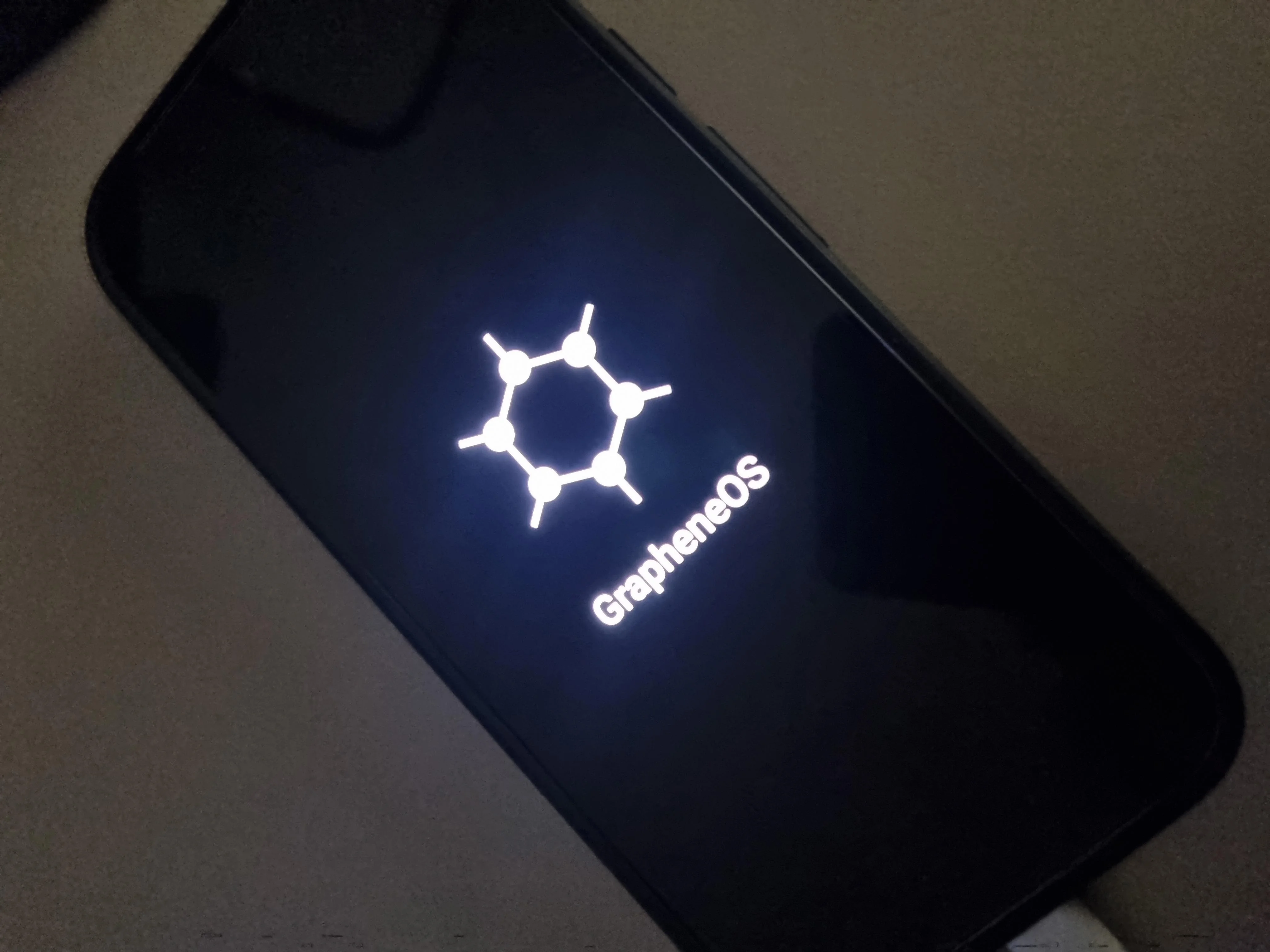 The GrapheneOS name and logo displayed on a screen