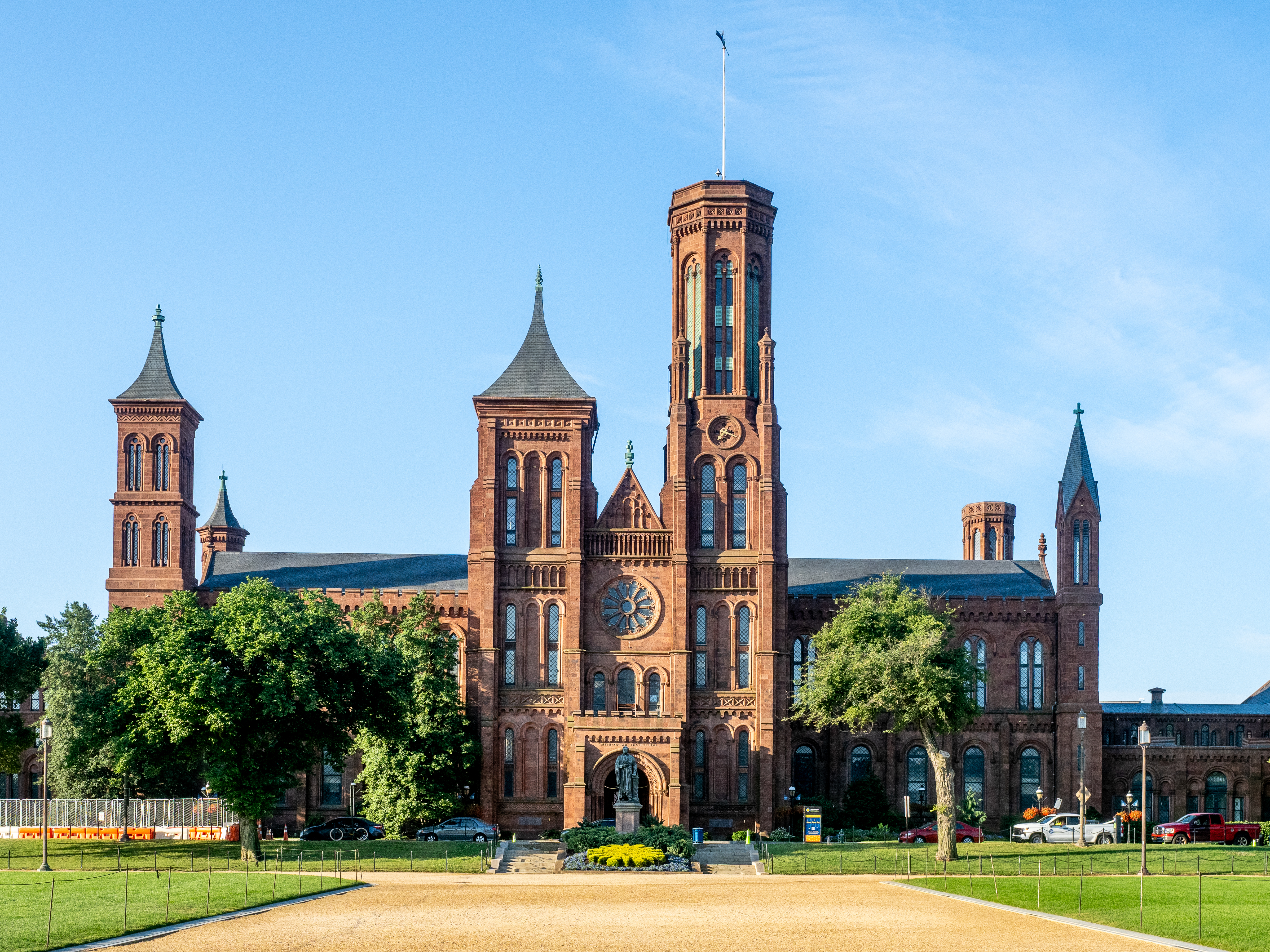 The Smithsonian Institution Building, known as the Castle, photographed from the National Mall in Washington, D.C., with visitors walking in front