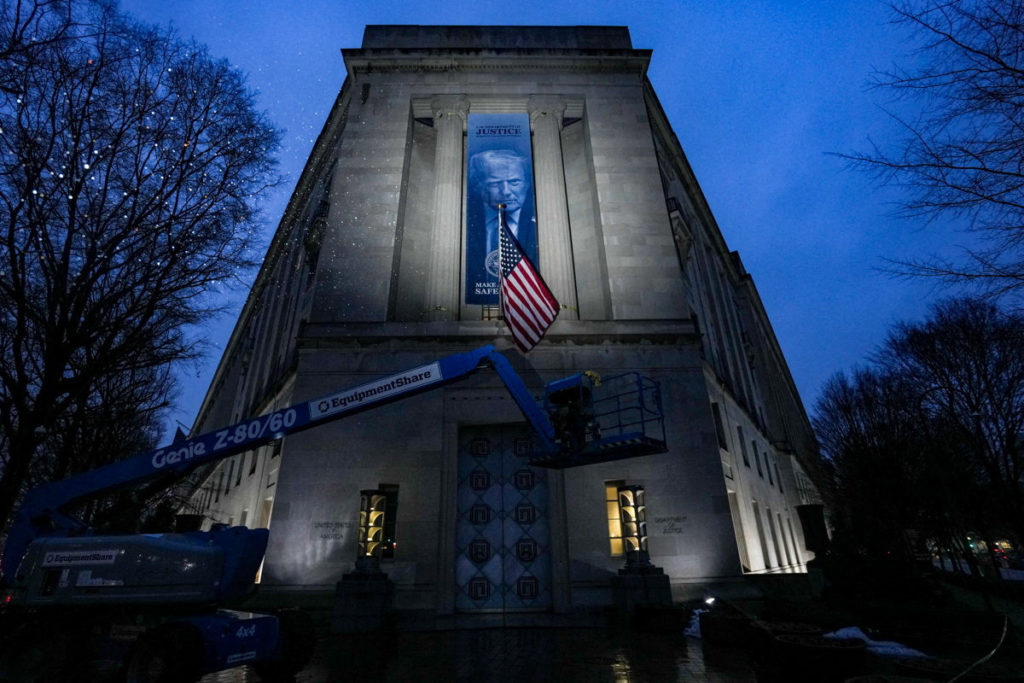 The U.S. Department of Justice building in Washington, D.C., exterior view with columns and signage, news photography style