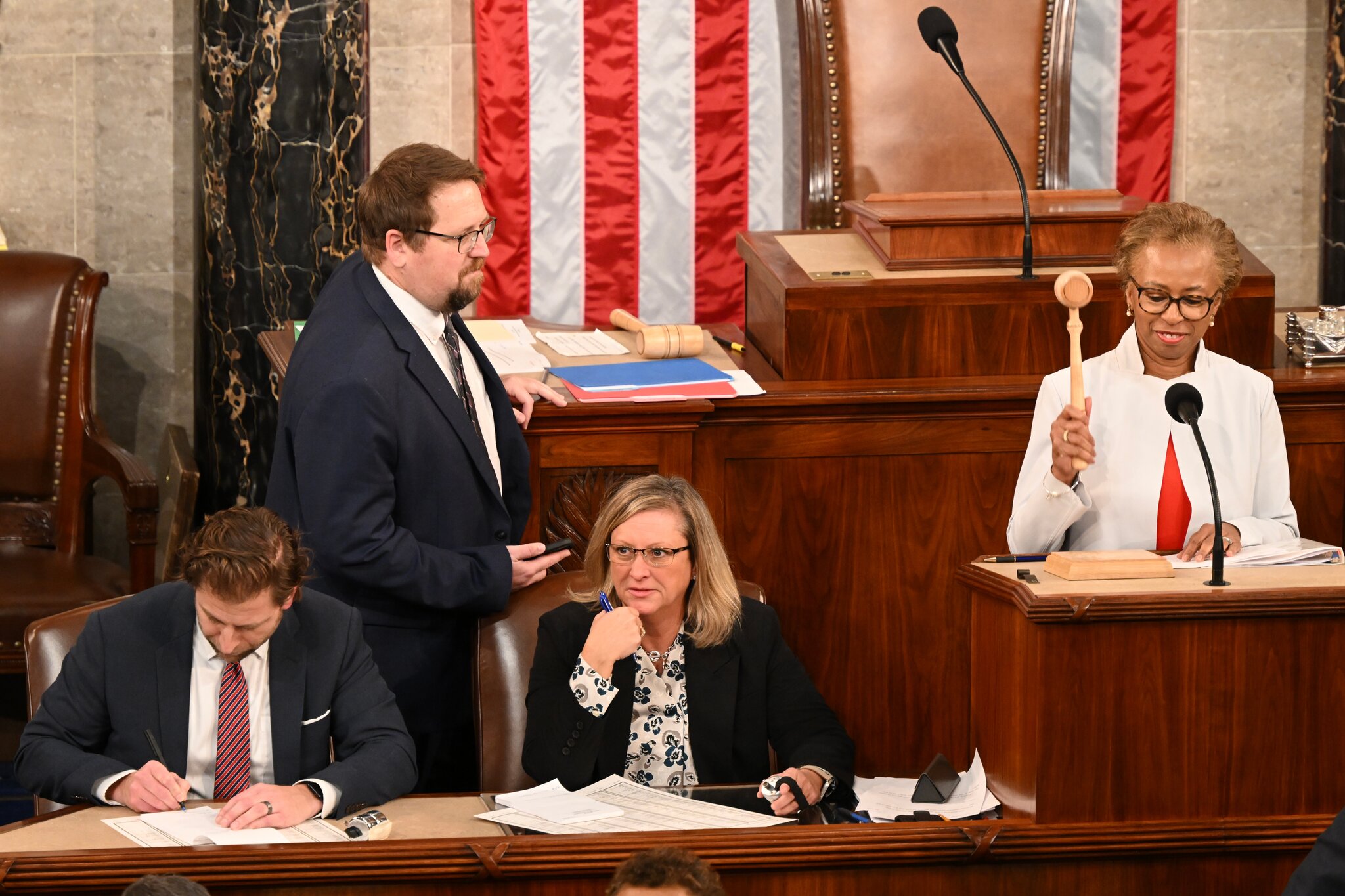 The U.S. House Parliamentarian seated near the rostrum in the House chamber
