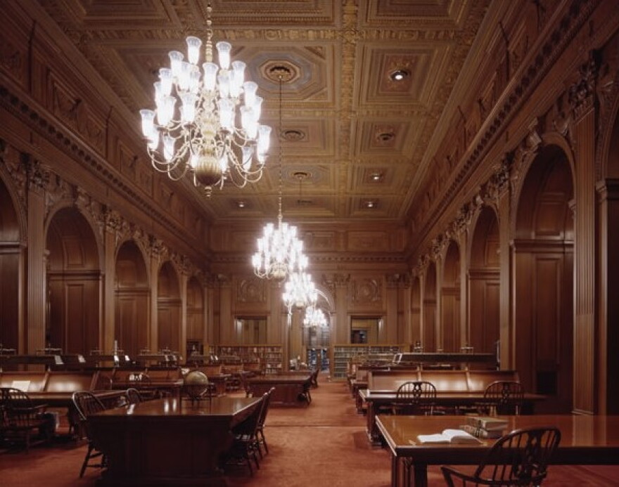 The U.S. Supreme Court library interior with shelves, tables, and reading lamps visible in a formal room