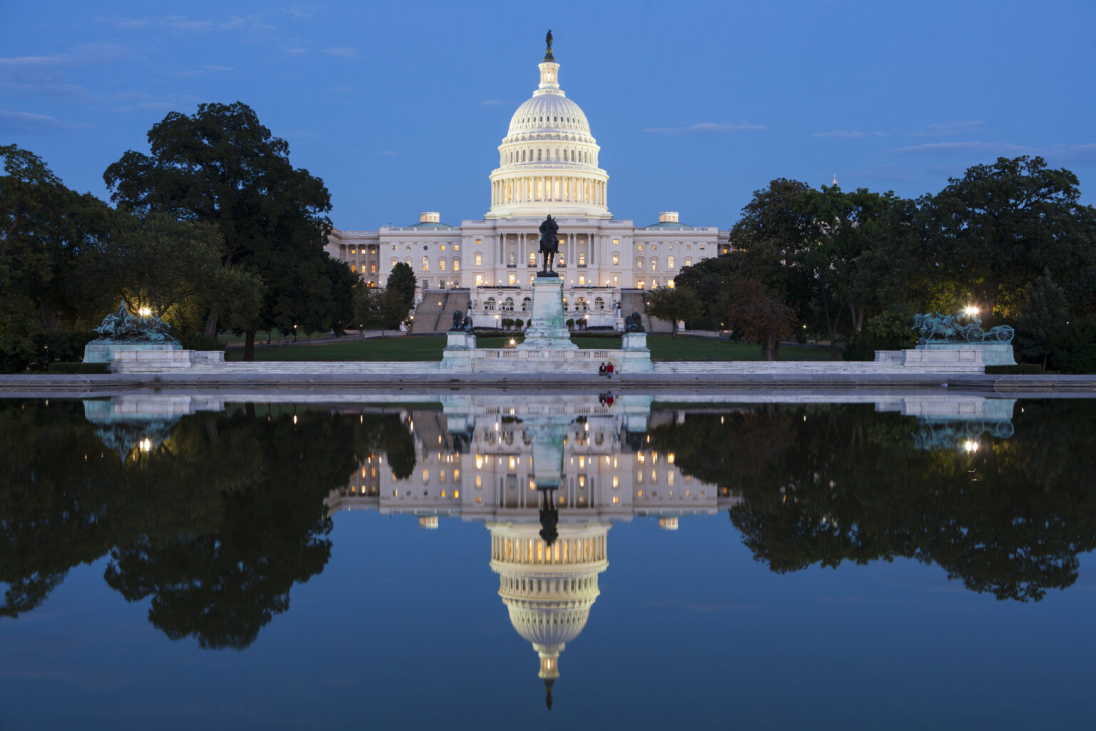 The United States Capitol building at dusk in Washington, DC, photographed from a distance with soft evening light, news photography style