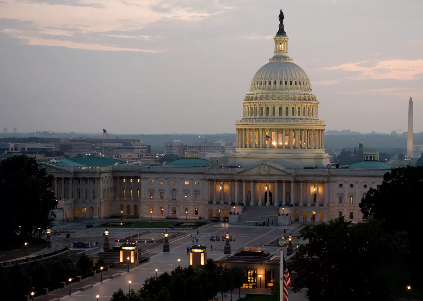 The United States Capitol building in Washington, D.C., photographed from the grounds with visitors in the distance
