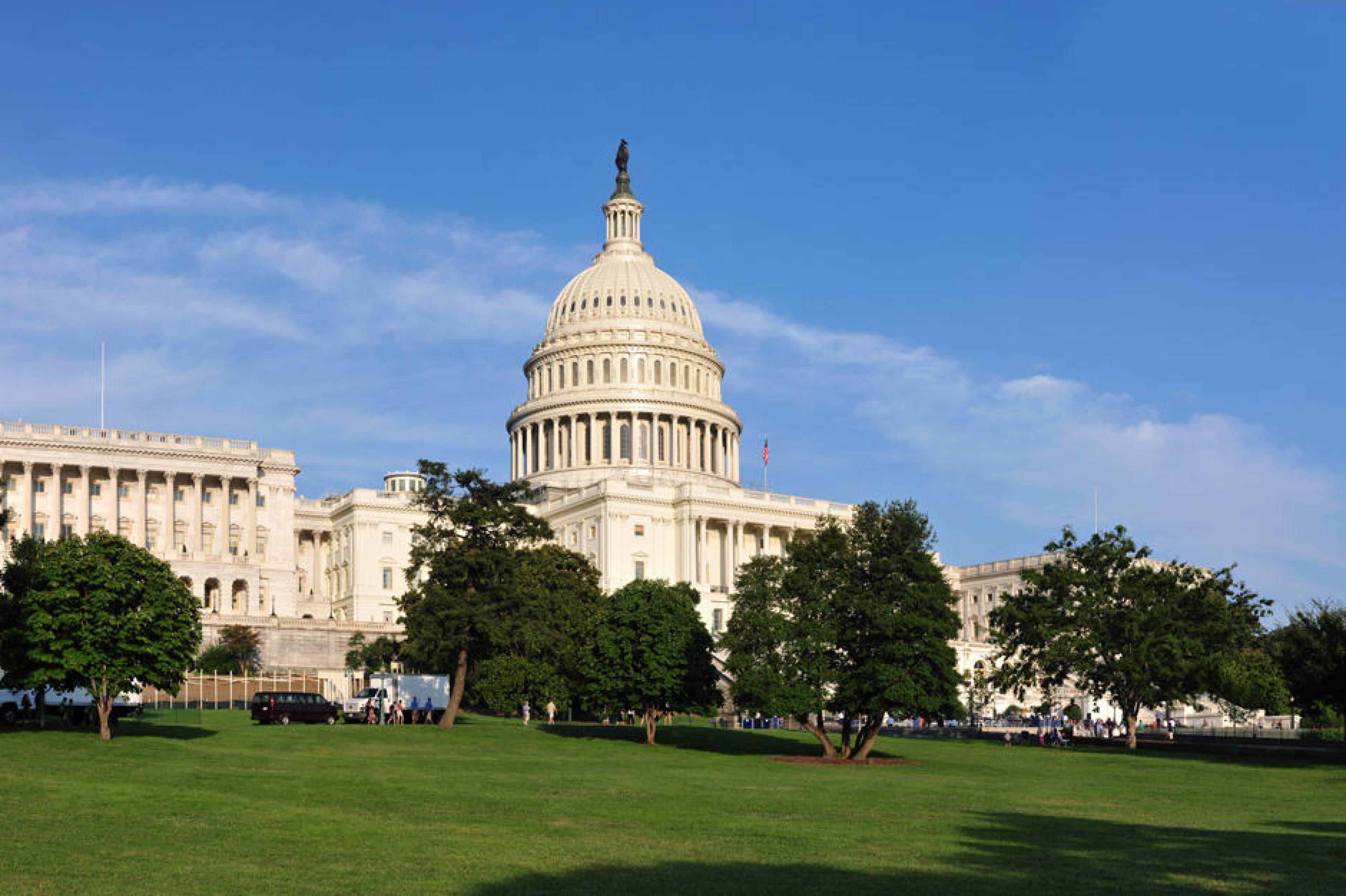 The United States Capitol building seen from the grounds on a clear day