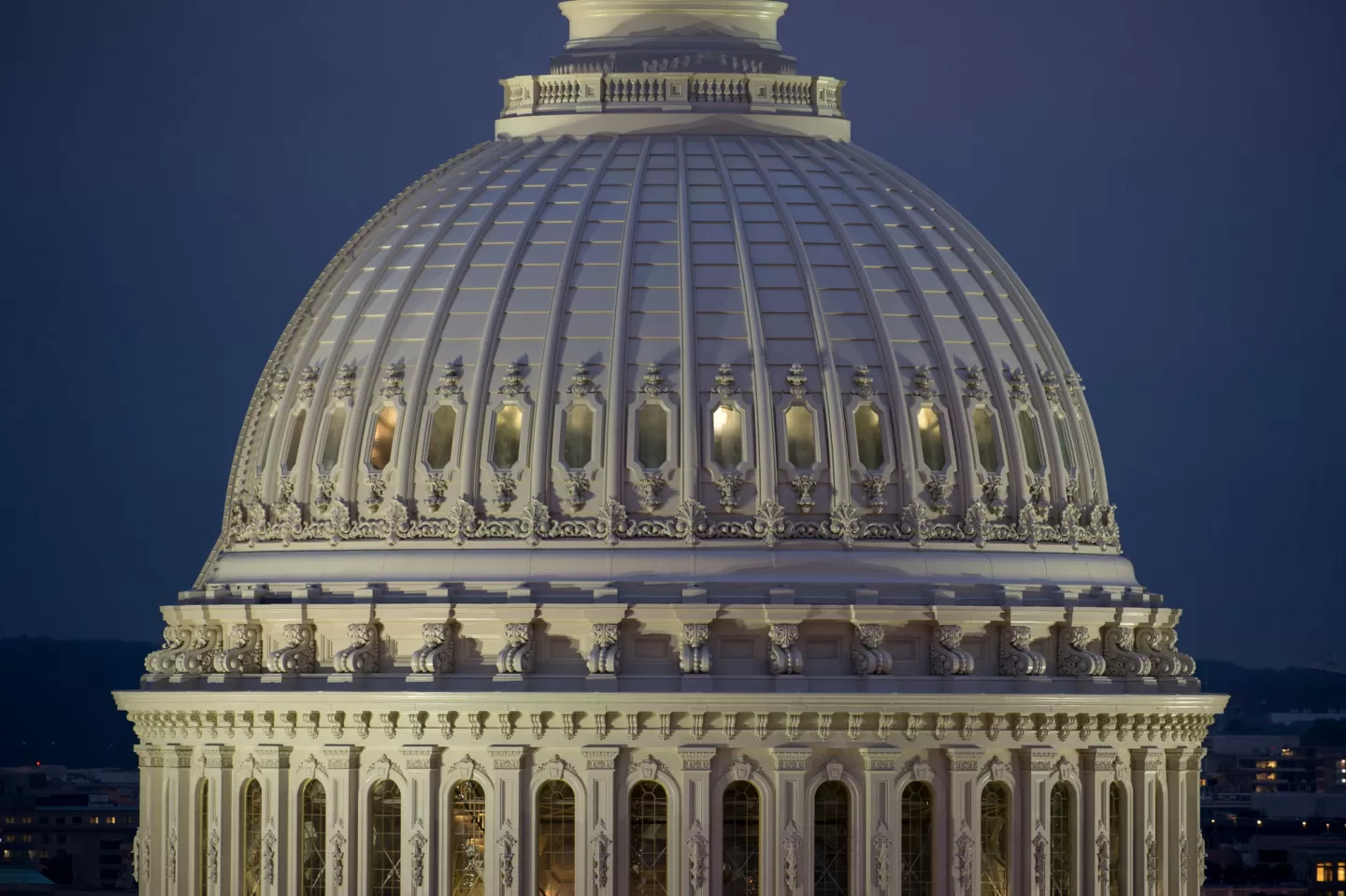 The United States Capitol in Washington, D.C., photographed from the lawn on a clear day, with the dome centered in frame