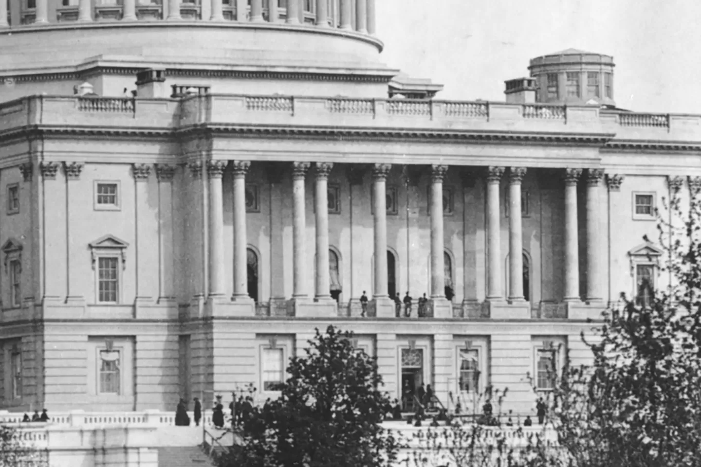 The United States Capitol in Washington, D.C., photographed from the lawn with the dome centered under a clear sky