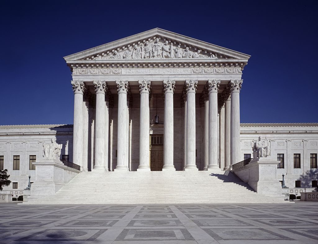 The United States Supreme Court building in Washington, DC, photographed from the front steps in clear daylight, editorial photography style