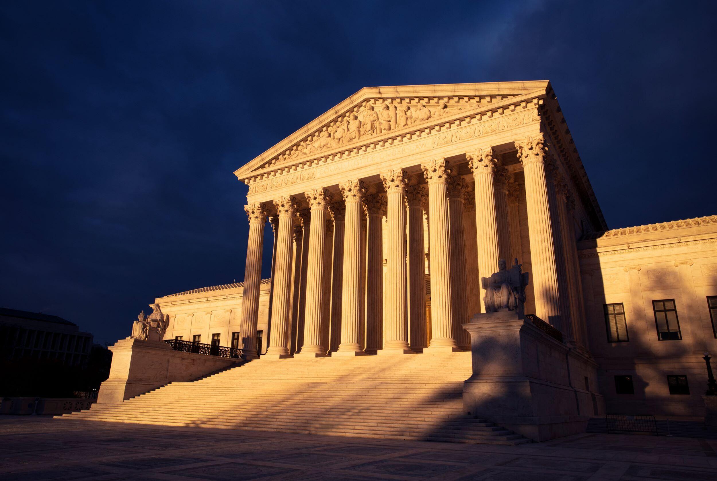 The United States Supreme Court building in Washington, DC, photographed from ground level with the front steps and columns visible