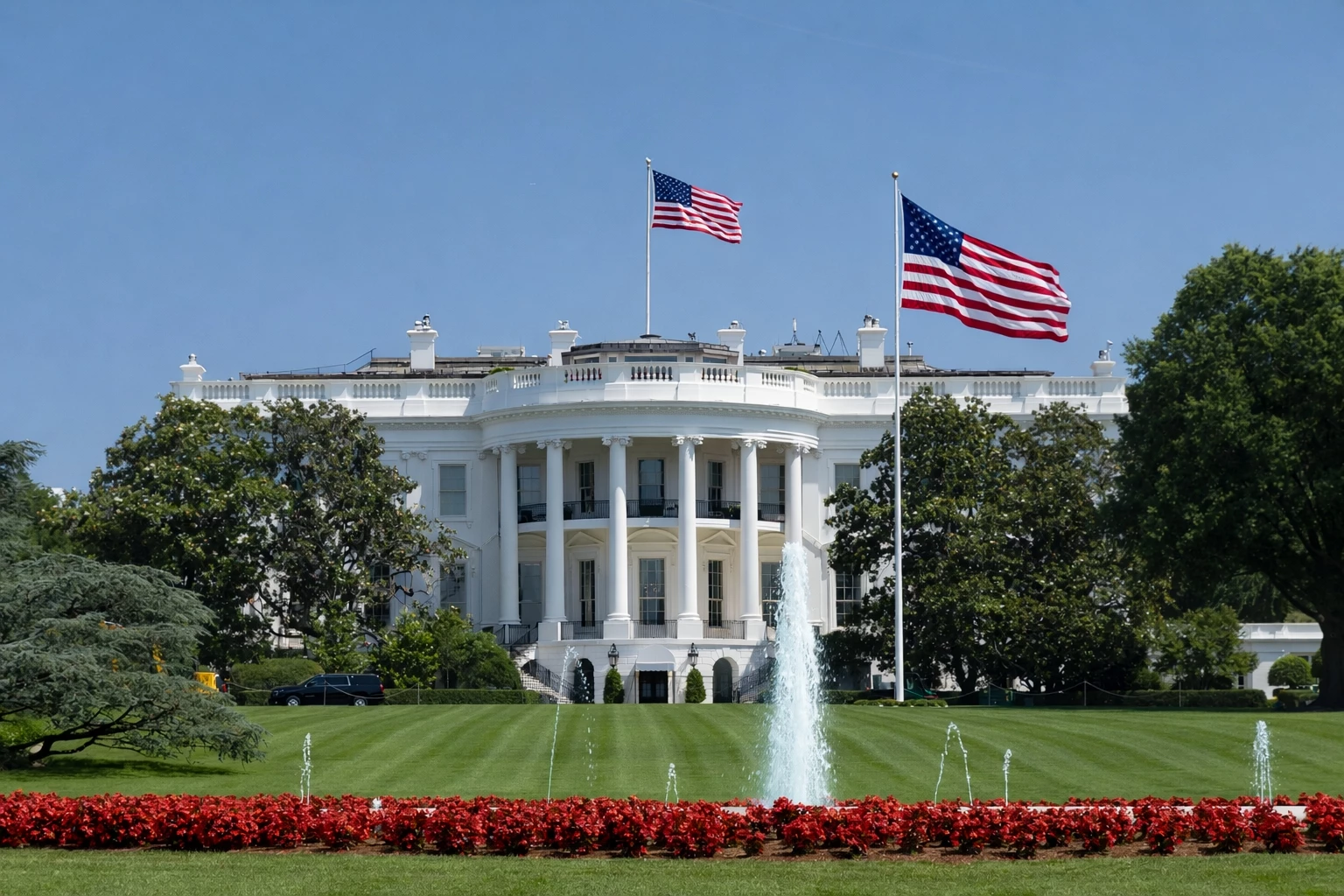 The White House complex in Washington, D.C., viewed from the North Lawn, showing the Executive Residence and surrounding grounds.