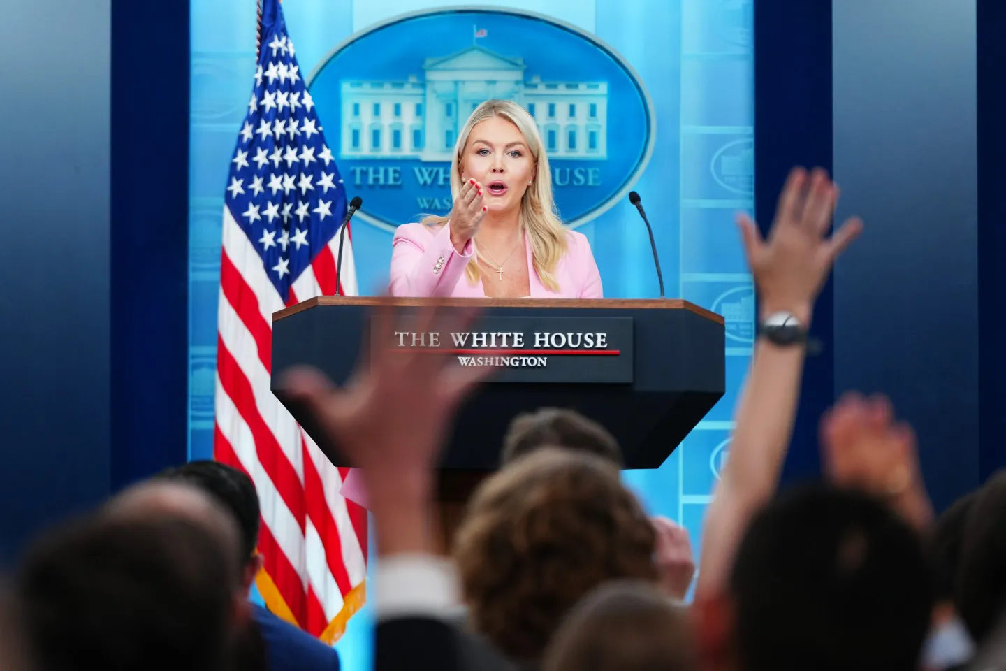 The White House press briefing room with the podium and backdrop visible, photographed during an official briefing setup
