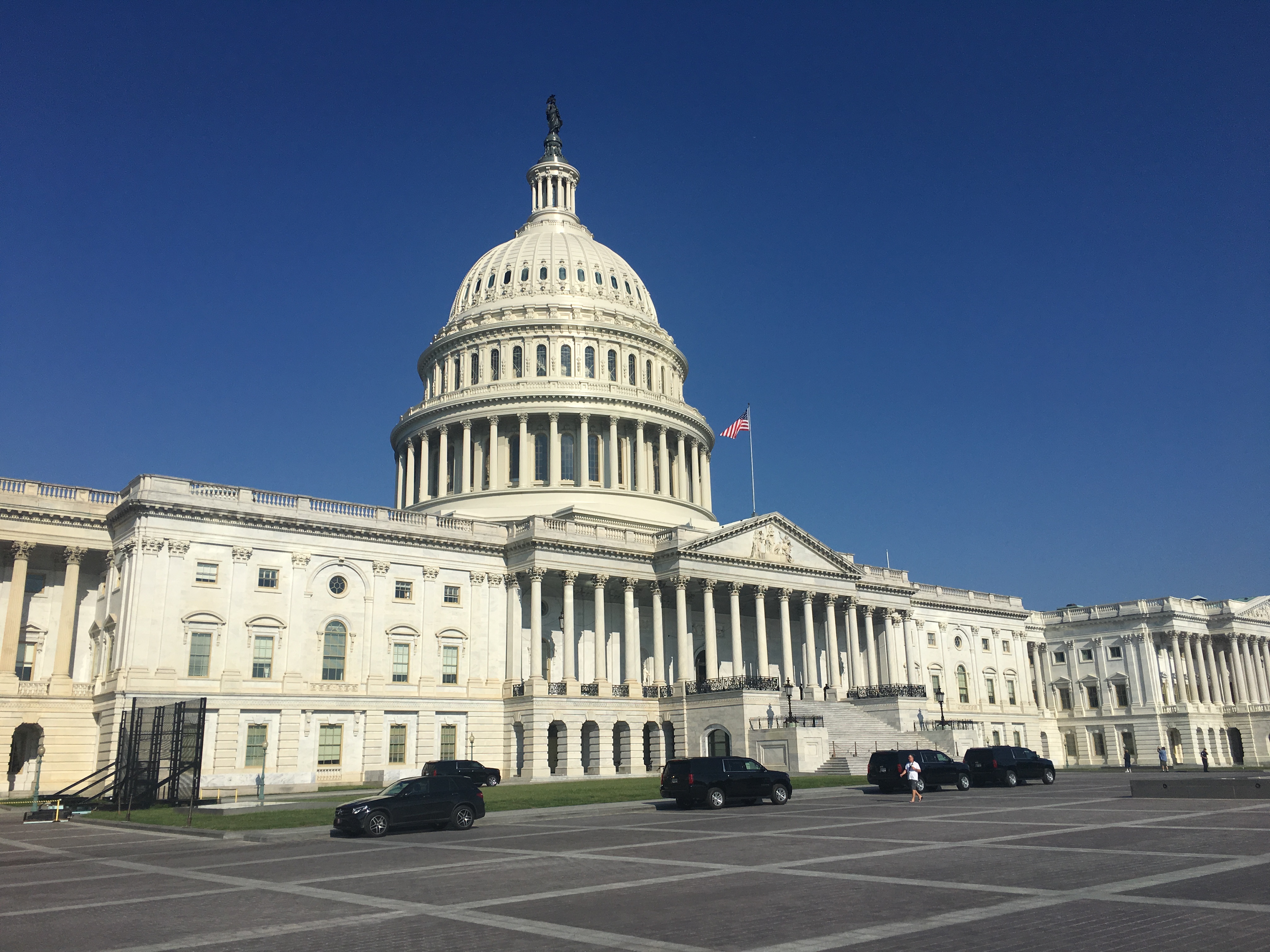 The east front of the United States Capitol in Washington, DC on a clear day, with steps and columns visible, real news photography style
