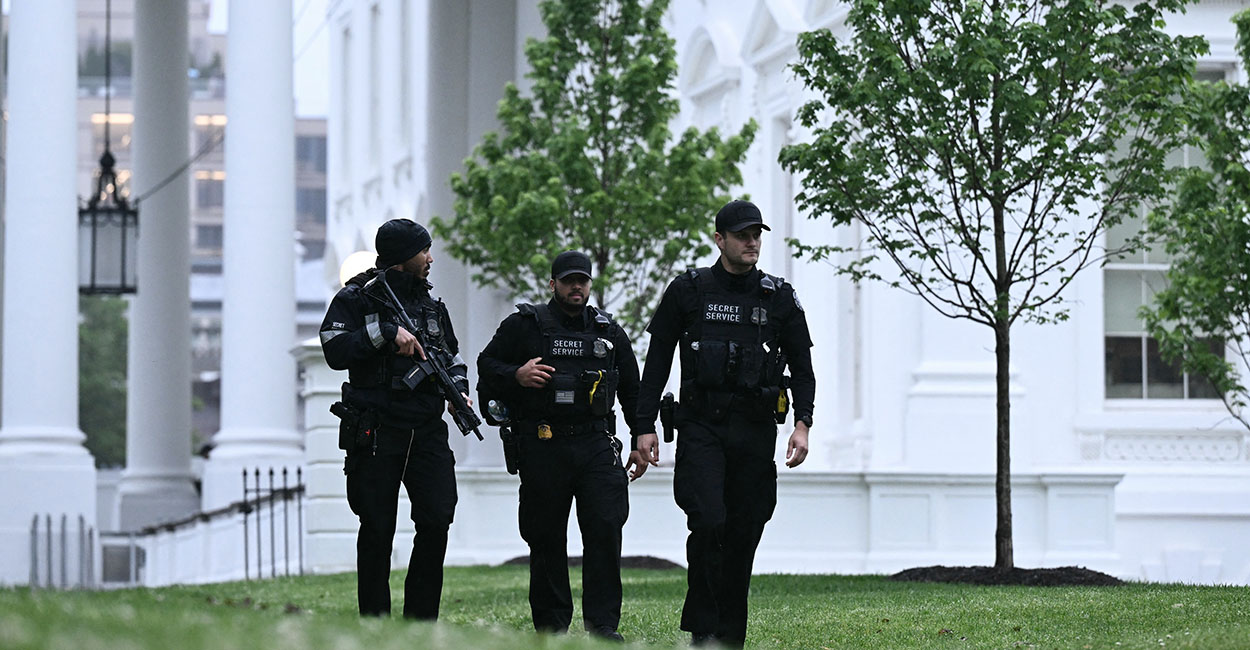 The entrance area to the West Wing of the White House with visible security and staff movement outside the doorway